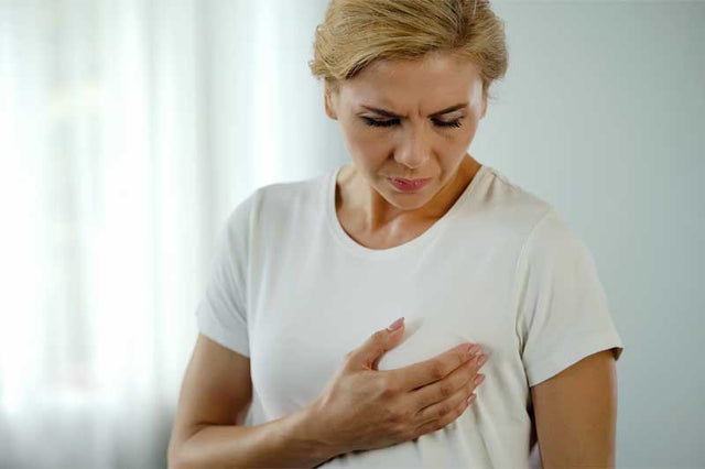 Concerned woman experiencing breast pain after menopause.