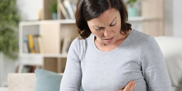 Woman experiencing one-sided breast pain during perimenopause.